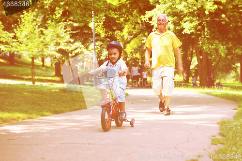Image of happy grandfather and child in park