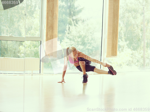 Image of woman stretching and warming up for her training at a gym