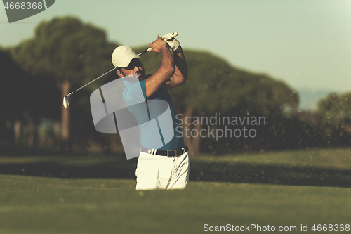 Image of pro golfer hitting a sand bunker shot