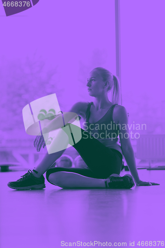 Image of woman stretching and warming up for her training at a gym