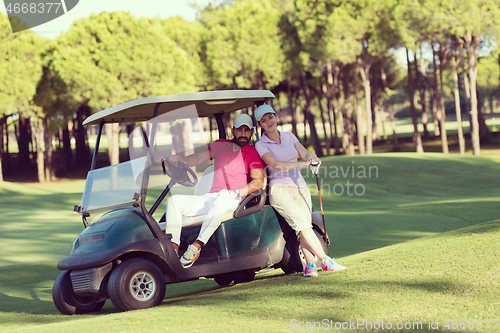 Image of couple in buggy on golf course