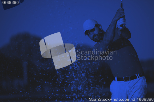 Image of pro golfer hitting a sand bunker shot