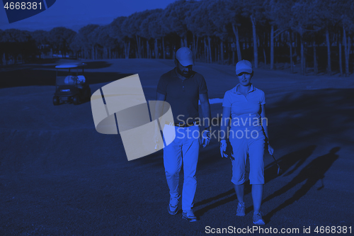 Image of couple walking on golf course