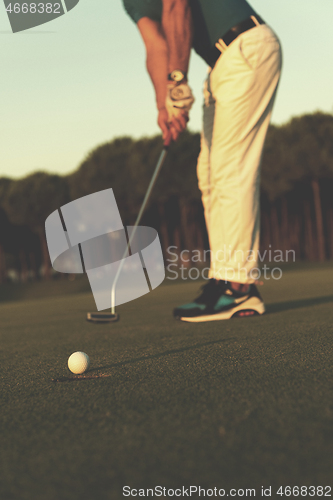 Image of golfer  hitting shot at golf course