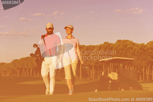 Image of couple walking on golf course