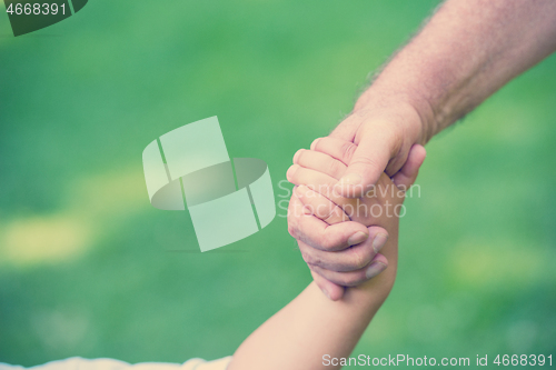 Image of grandfather and child have fun  in park