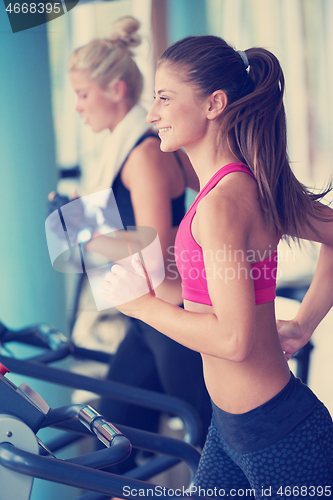 Image of woman exercising on treadmill in gym