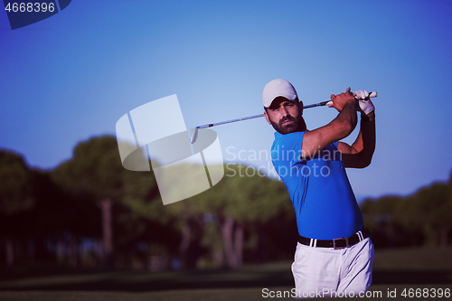 Image of pro golfer hitting a sand bunker shot