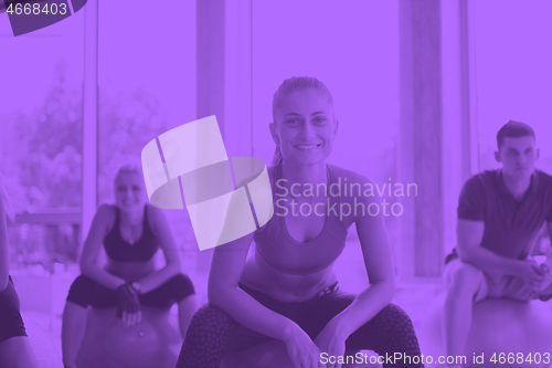 Image of group of people exercise with balls on yoga class