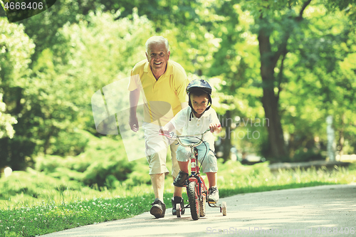 Image of happy grandfather and child in park