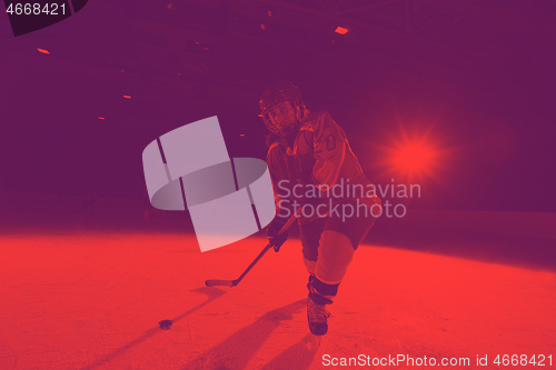 Image of teen ice hockey player in action