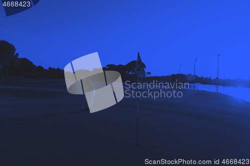 Image of golfer hitting ball to hole