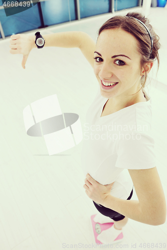 Image of happy diet concept with young woman on pink scale