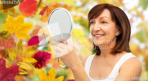 Image of portrait of smiling senior woman with mirror