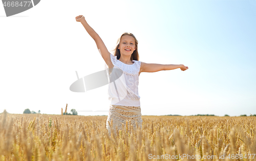 Image of happy smiling young girl on cereal field in summer