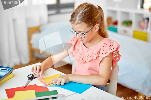 Image of creative girl making greeting card at home