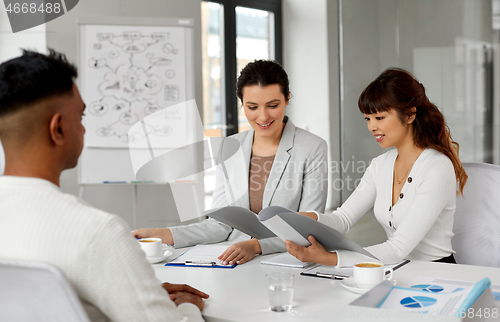 Image of recruiters having job interview with male employee