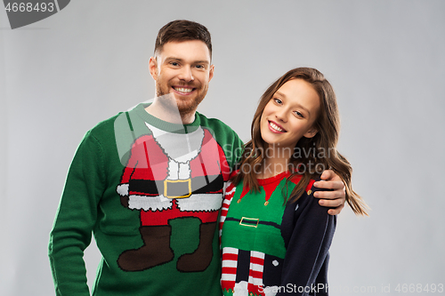 Image of happy couple at christmas ugly sweater party