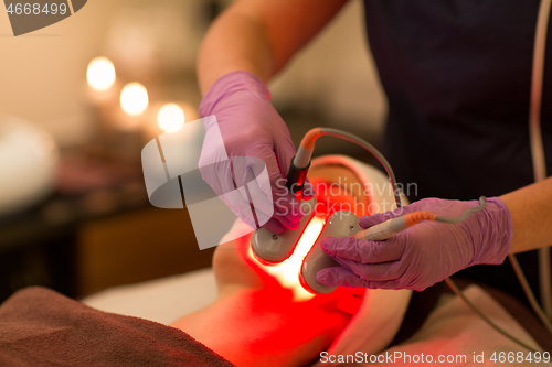 Image of young woman having face microdermabrasion at spa