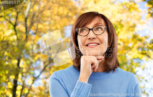 Image of portrait of senior woman in glasses dreaming