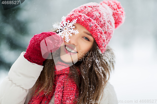 Image of portrait of teenage girl with snowflake in winter