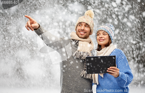 Image of couple in winter clothes with tablet computer