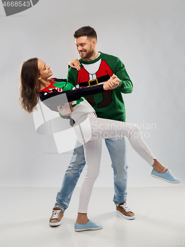 Image of couple dancing at christmas ugly sweater party