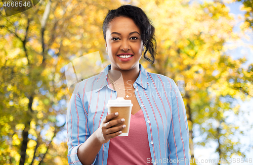 Image of happy african american woman drinking coffee