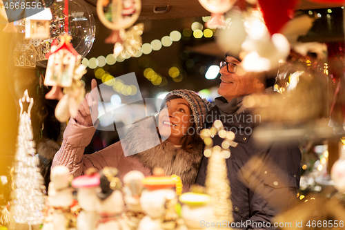 Image of senior couple at christmas market souvenir shop
