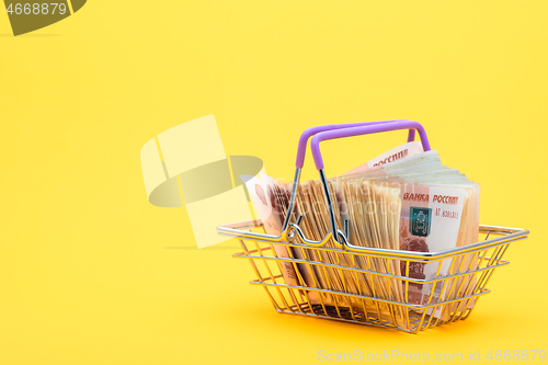 Image of In the grocery cart are Russian banknotes of five thousand rubles