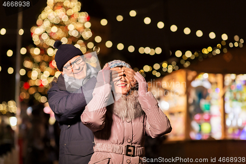 Image of happy senior couple at christmas market