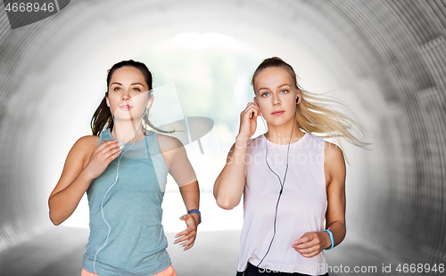 Image of women or female friends with earphones running