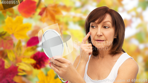 Image of portrait of smiling senior woman with mirror