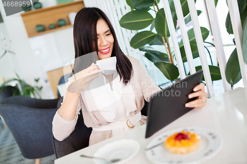 Image of asian woman with tablet pc at cafe or coffee shop