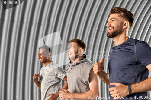 Image of young men or male friends running outdoors