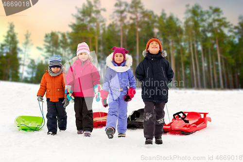 Image of happy little kids with sleds in winter