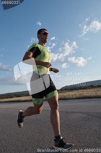 Image of triathlon athlete running on morning trainig