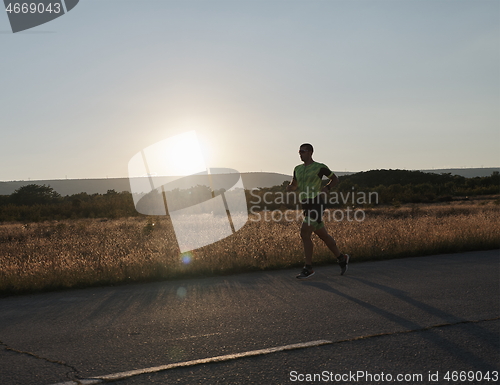 Image of triathlon athlete running on morning trainig