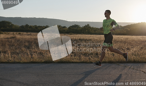 Image of triathlon athlete running on morning trainig