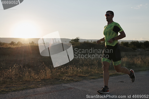 Image of triathlon athlete running on morning trainig