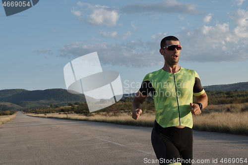 Image of triathlon athlete running on morning trainig