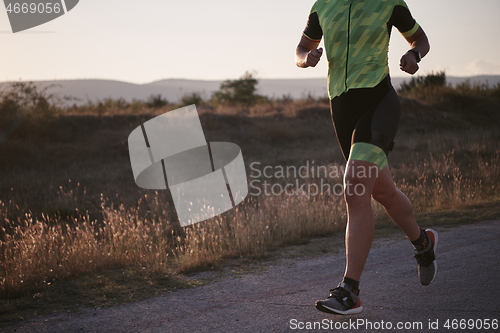 Image of triathlon athlete running on morning trainig