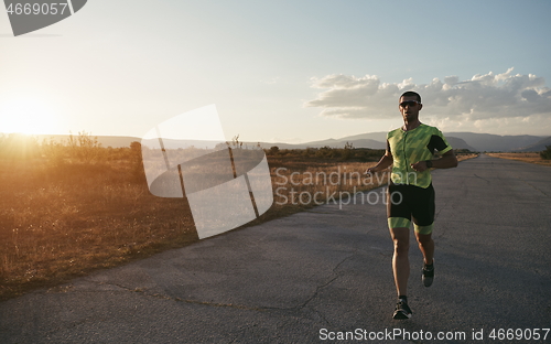 Image of triathlon athlete running on morning trainig