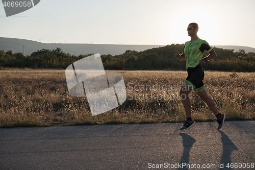 Image of triathlon athlete running on morning trainig