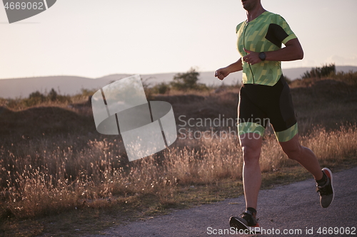 Image of triathlon athlete running on morning trainig