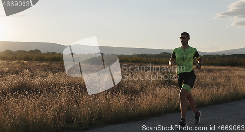 Image of triathlon athlete running on morning trainig