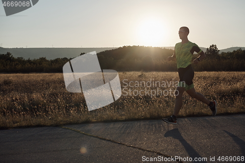 Image of triathlon athlete running on morning trainig