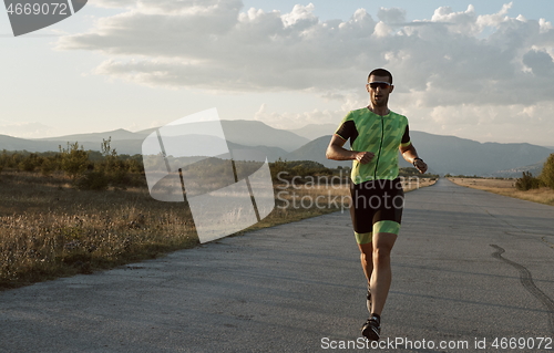 Image of triathlon athlete running on morning trainig