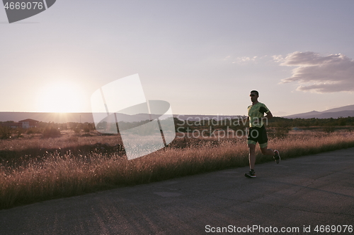 Image of triathlon athlete running on morning trainig