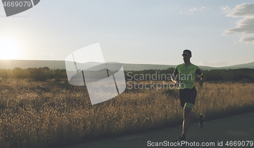 Image of triathlon athlete running on morning trainig